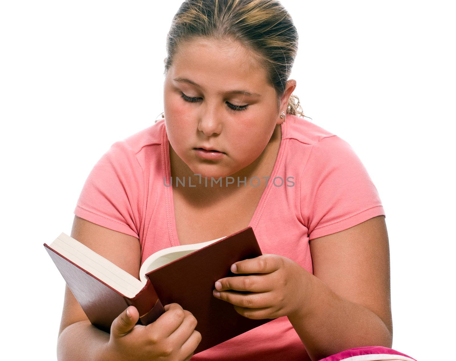 A young girl reading a book, isolated against a white background