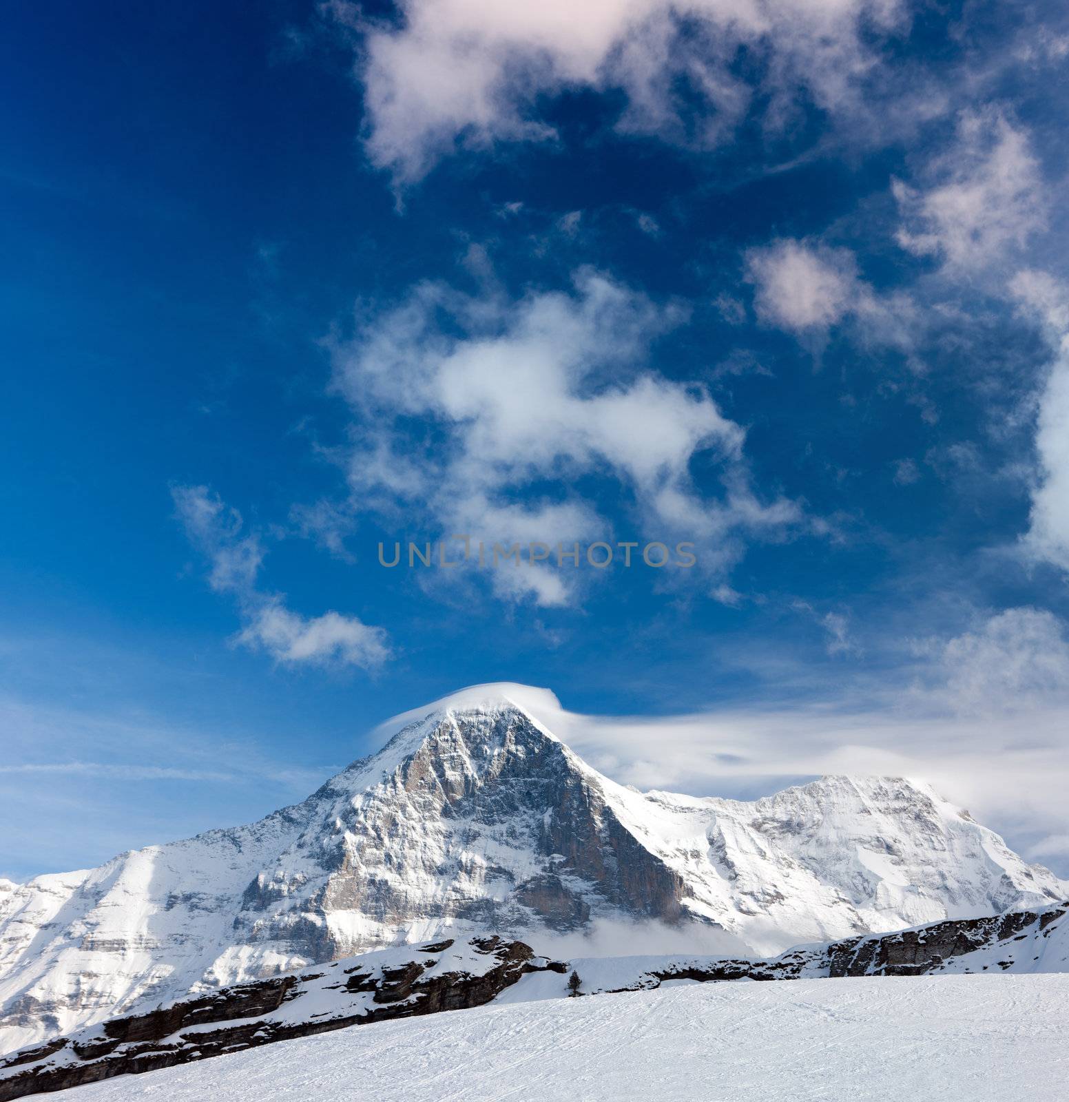 Ski slope in the background of Mount Eiger. The Eiger is a mountain in the Bernese Alps in Switzerland.
