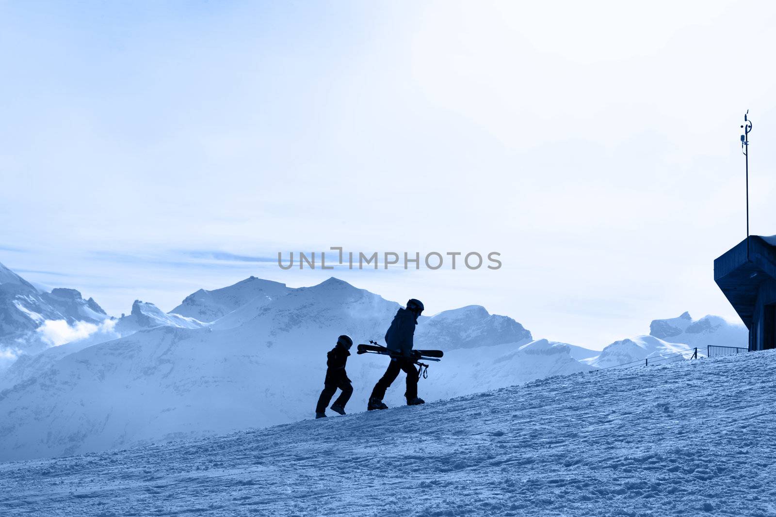 Ski slope. Skiers on the background of the Bernese Alps.