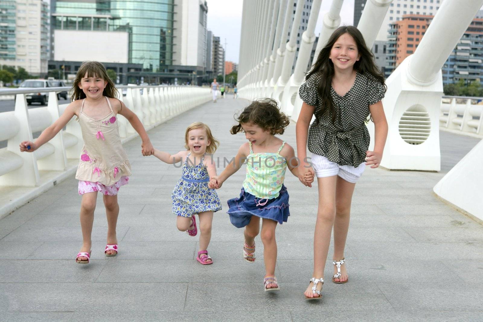 Four little girl group walking in the city by lunamarina