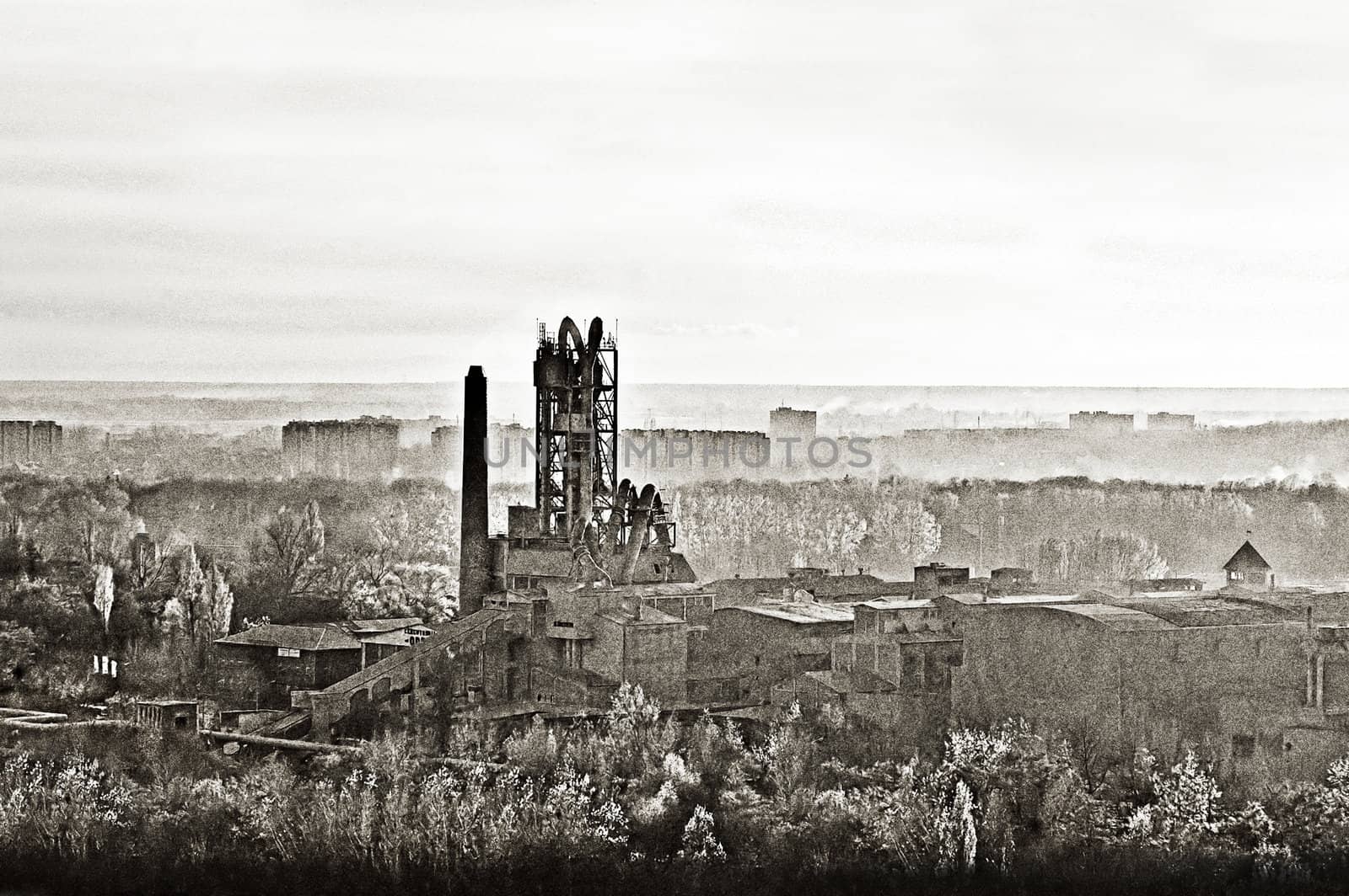 Old cement factory, old style photo, urban view,  noisy sepia
