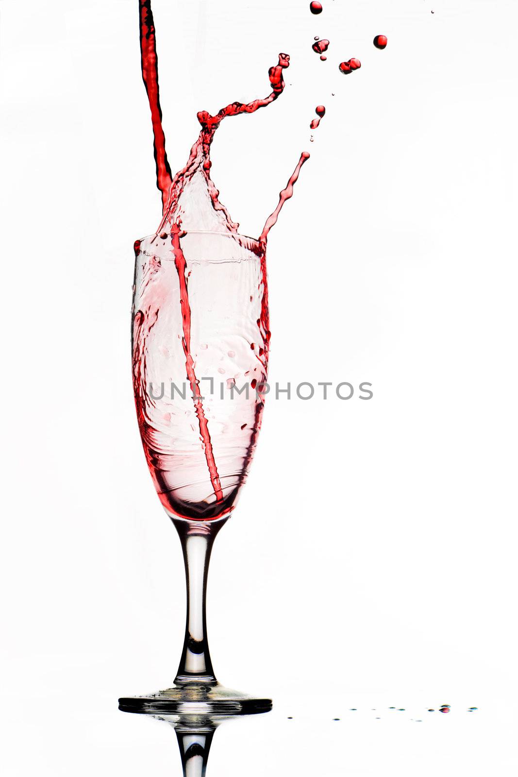 Pouring red wine. Wine splash isolated on white. 