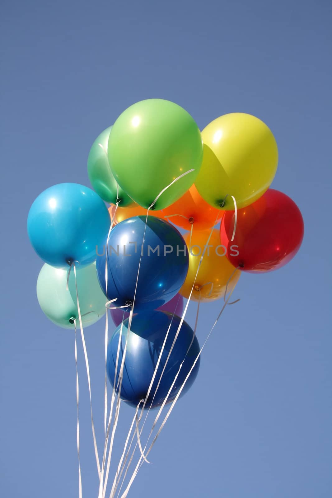 Colorful balloons in a bright blue sky