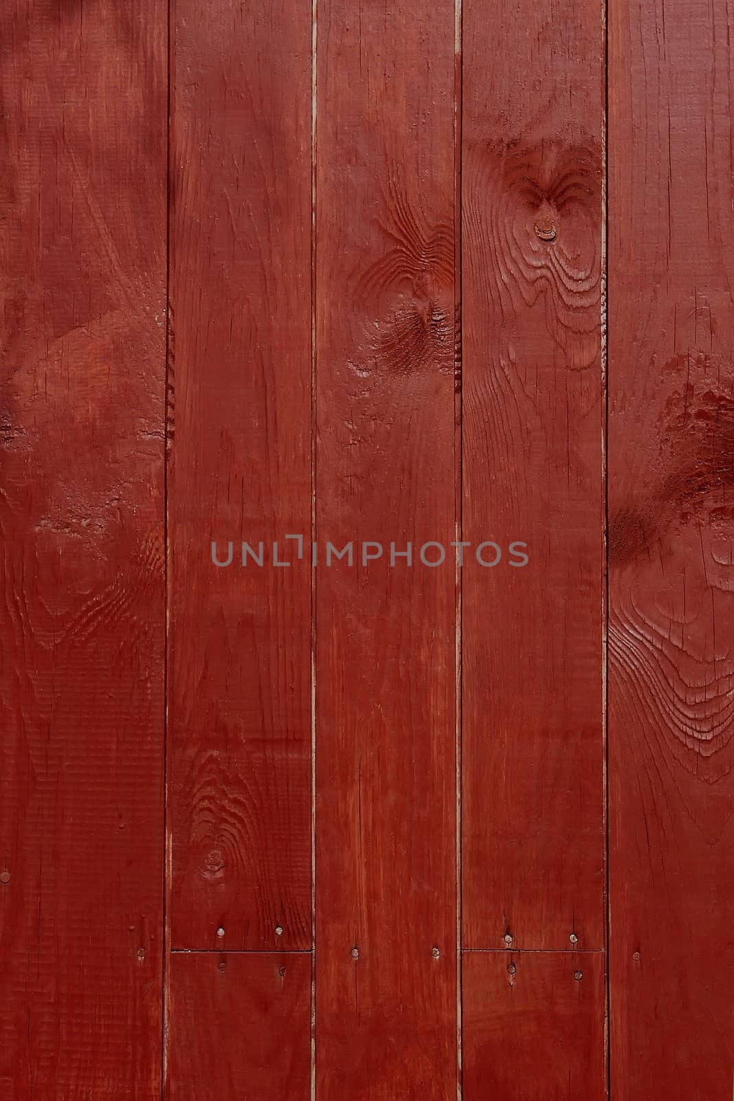 Parallel vertical wooden planks, painted in red