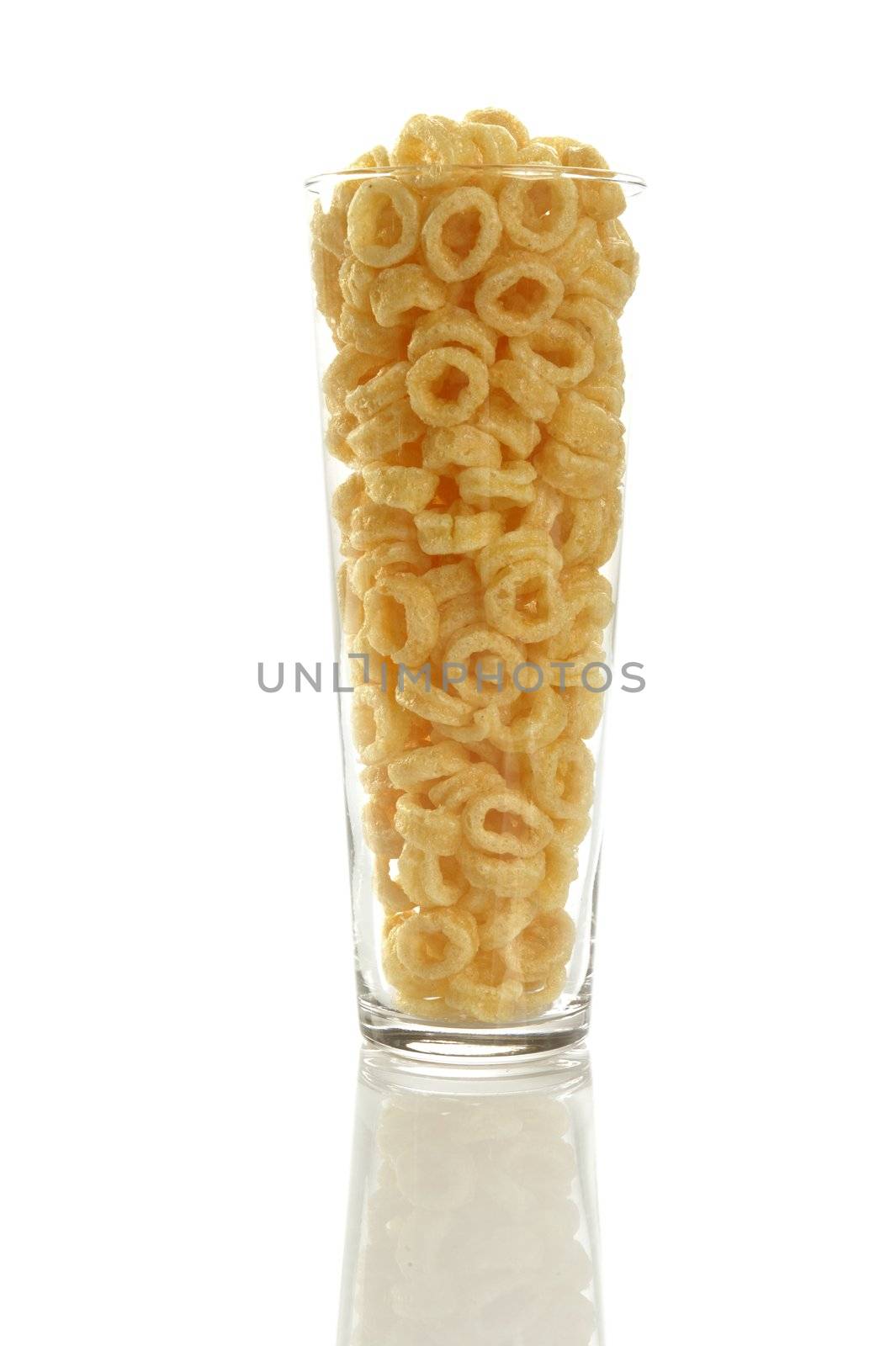 Corn round ring snacks in a vertical high glass over white