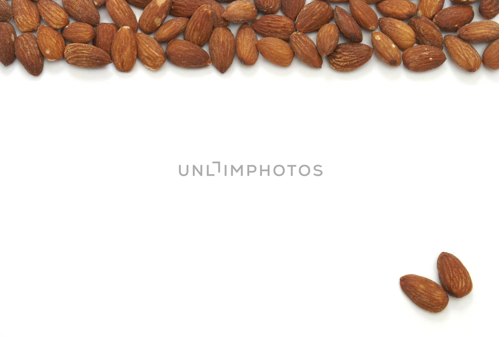 An almond pile at the top and two seperate almonds on the bottom.