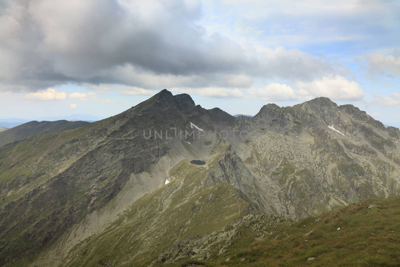 Caltun lake and important peaks (Caltun, Lespezi and in the distance Negoiu-the highest peak of this mountain range) in Fagras Mountains,from Romania.