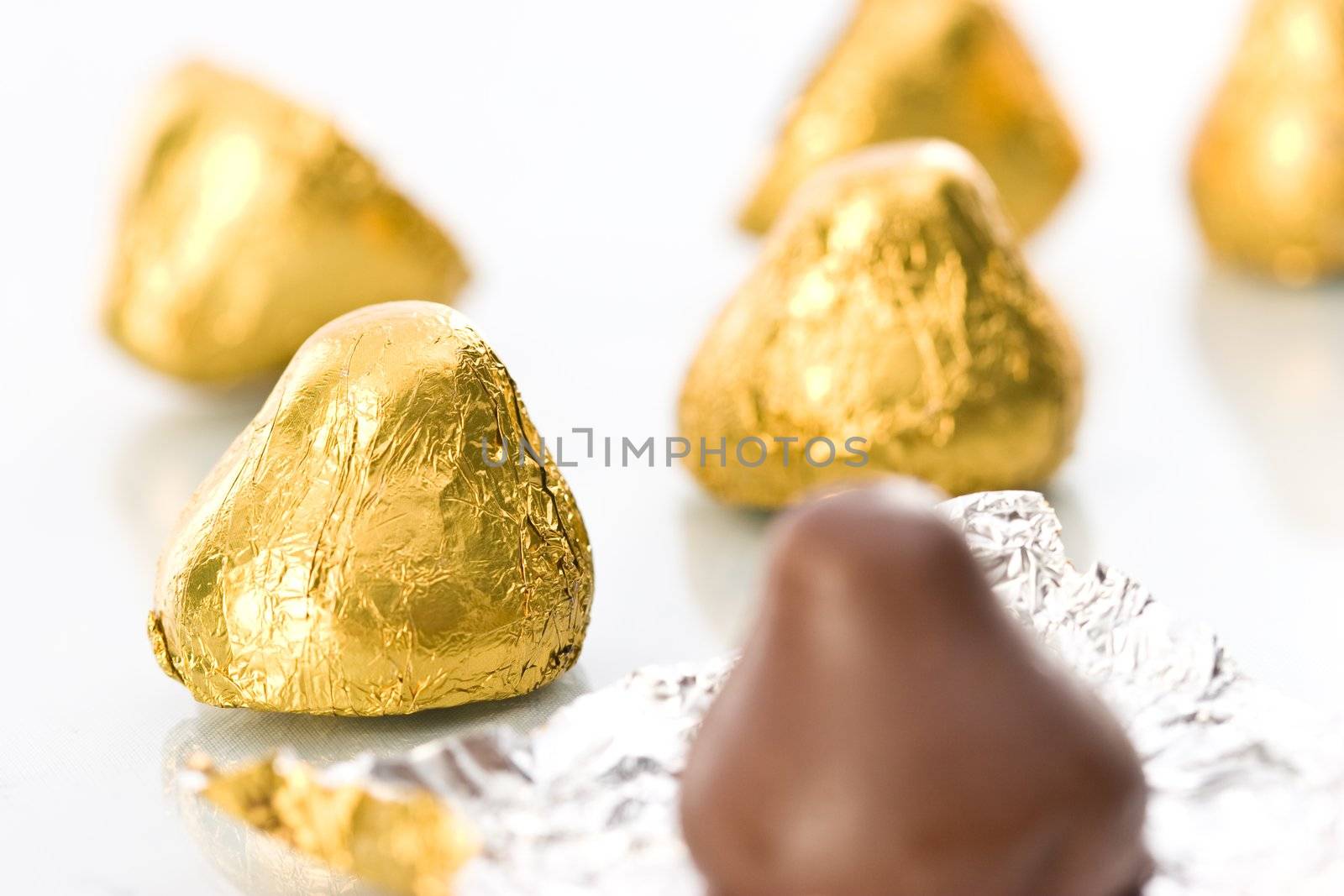 sweet, chocolate candy on the golden foil