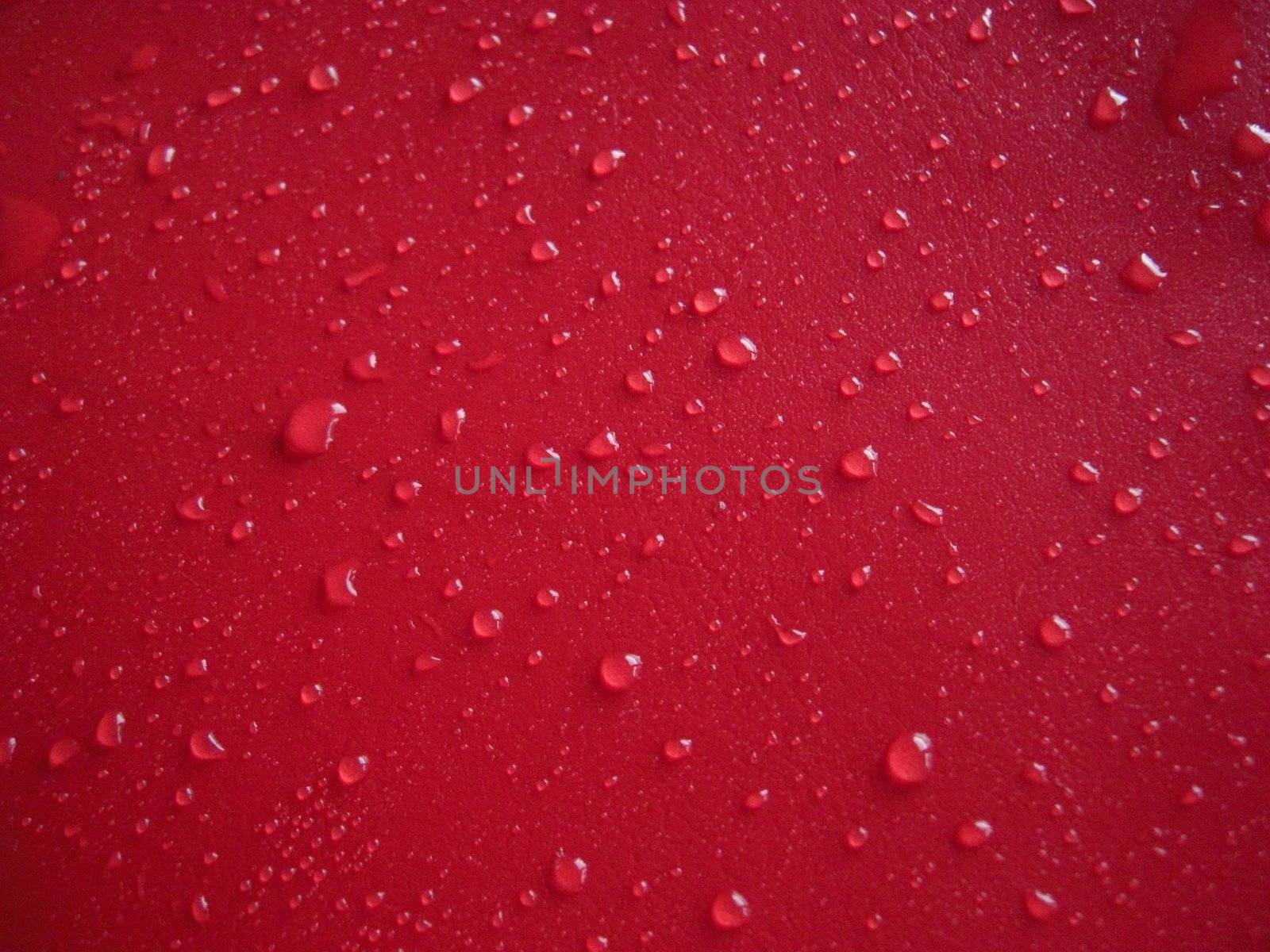 waterdrops distributed on red background