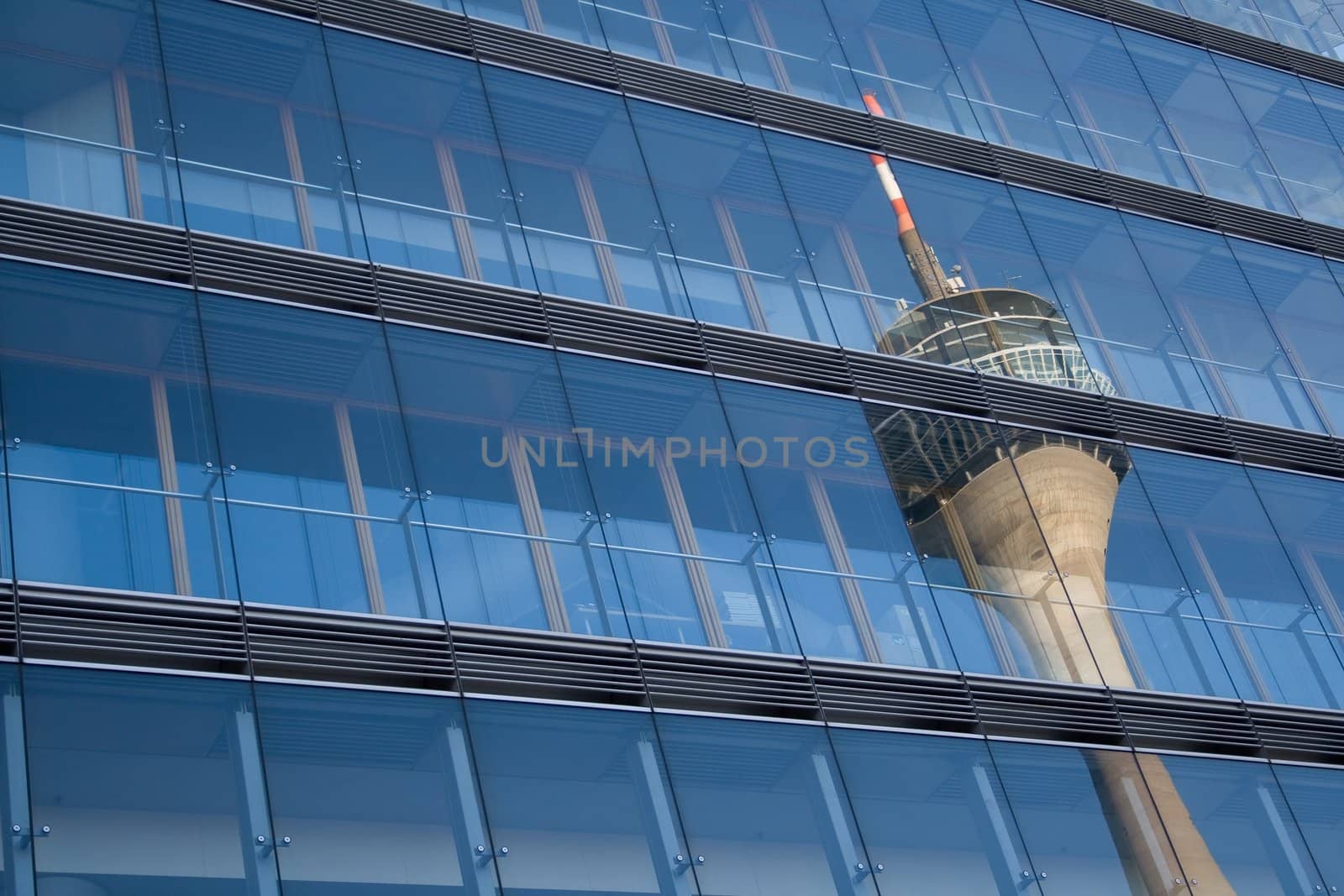 Telecommunications tower reflected in a skyscraper