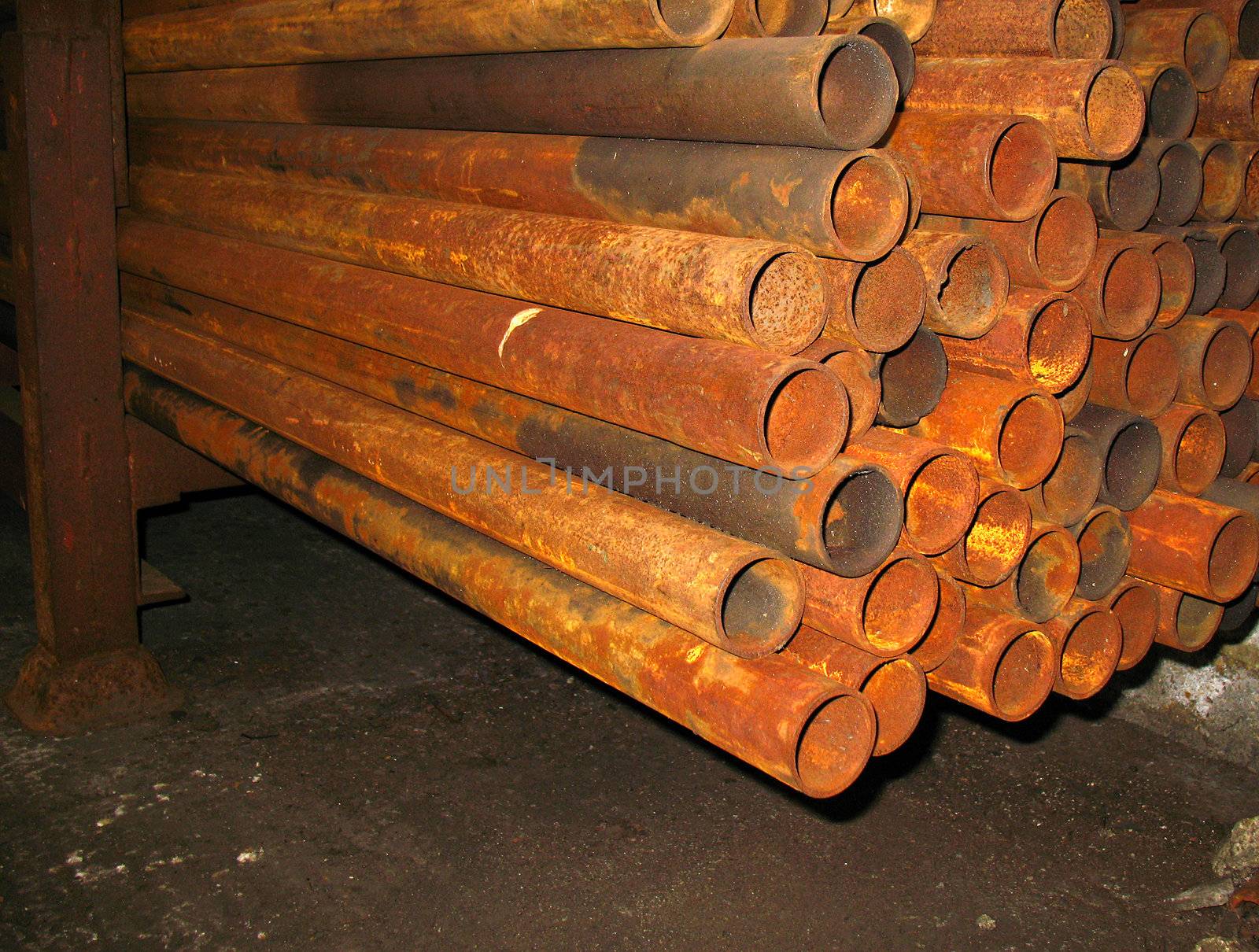 stock of rusty metal pipes in engineering shop
