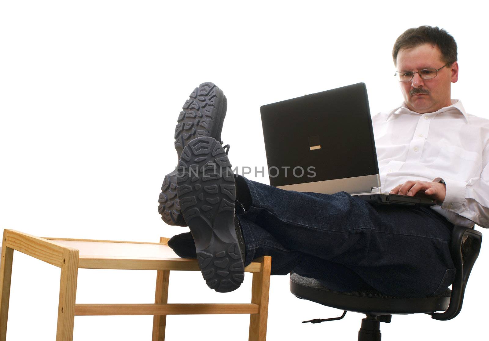 Businessman at work with laptop isolated on white