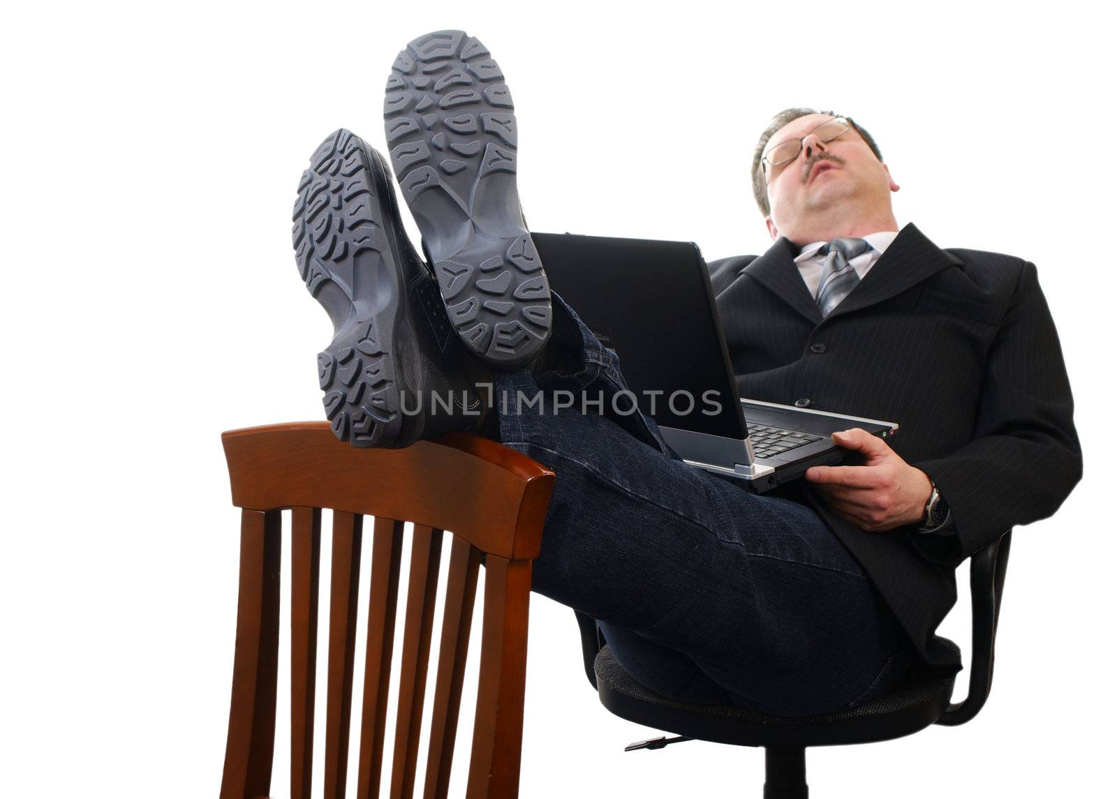 Tired businessman sleep at work with laptop isolated on white.