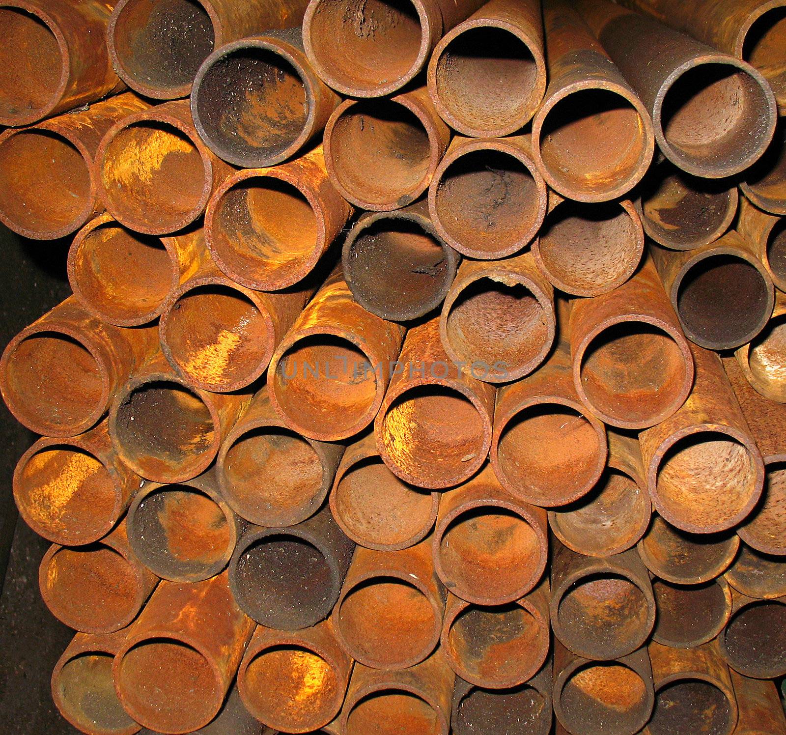stock of rusty metal pipes in engineering shop

