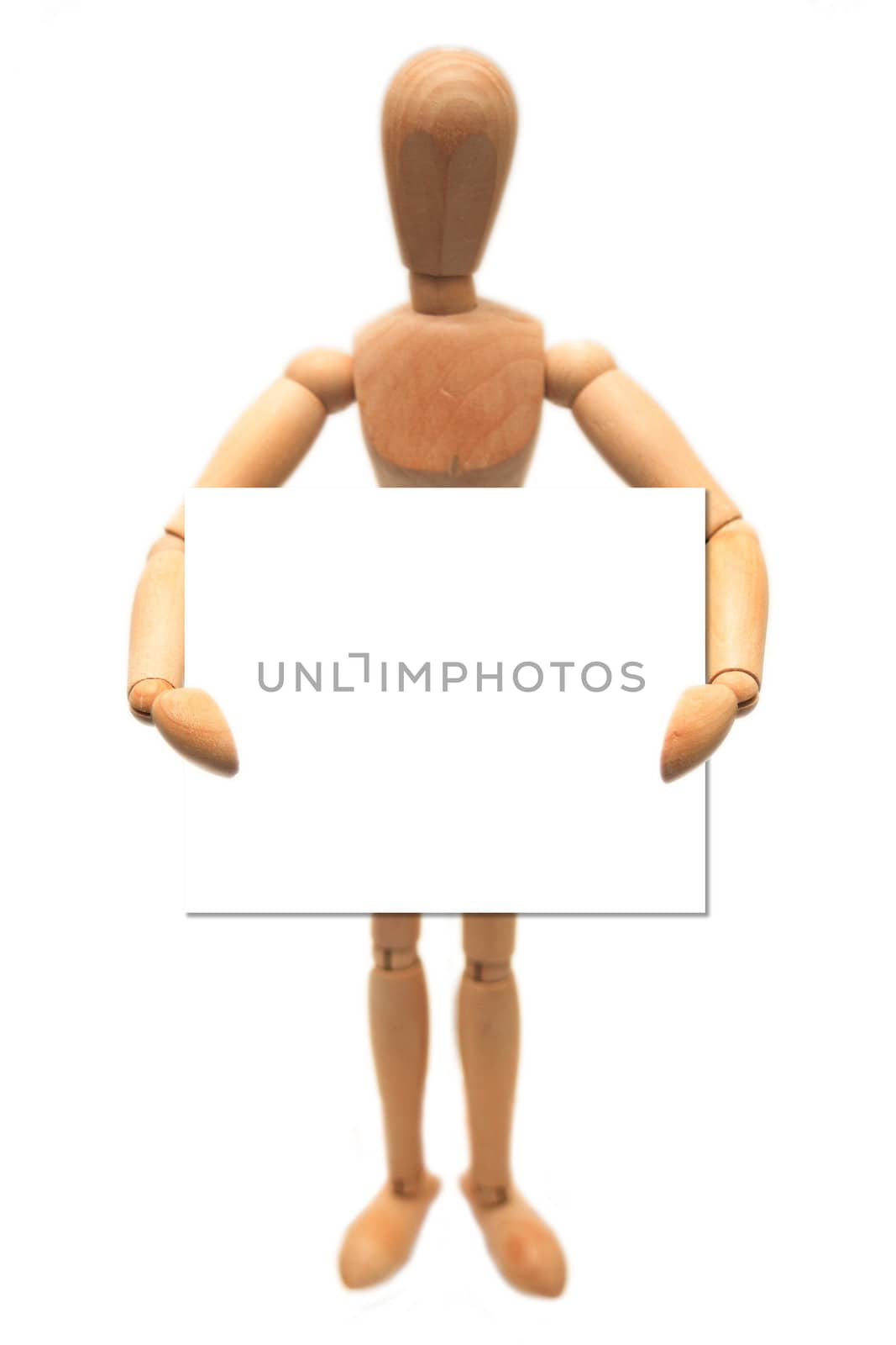 A wooden dummy, holding a white card, isolated on white.