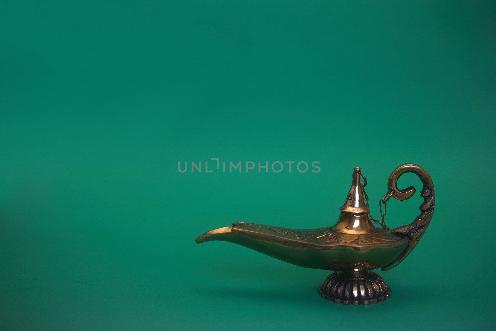 An isolated golden or bronze magic genie lamp, like Aladdins! :)