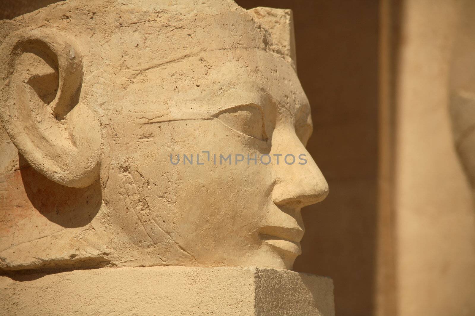 A large stone egyptian statue outside the Hatshepsut Temple in Luxor.