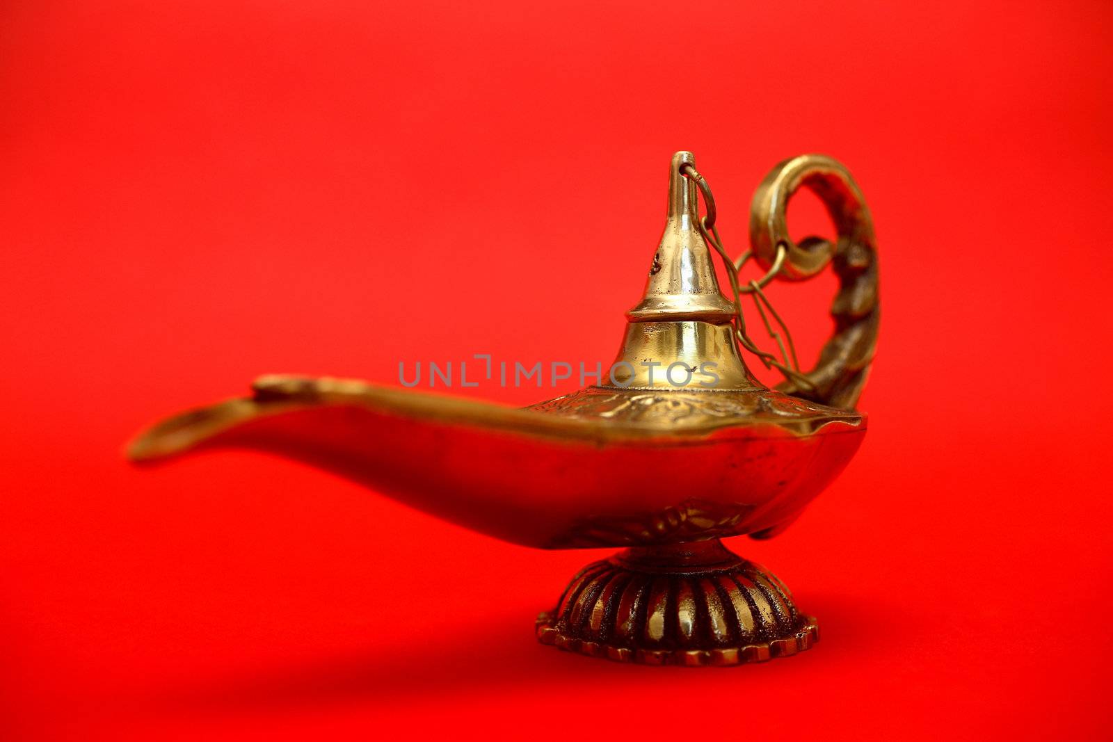 An isolated golden or bronze magic genie lamp, like Aladdins! :)