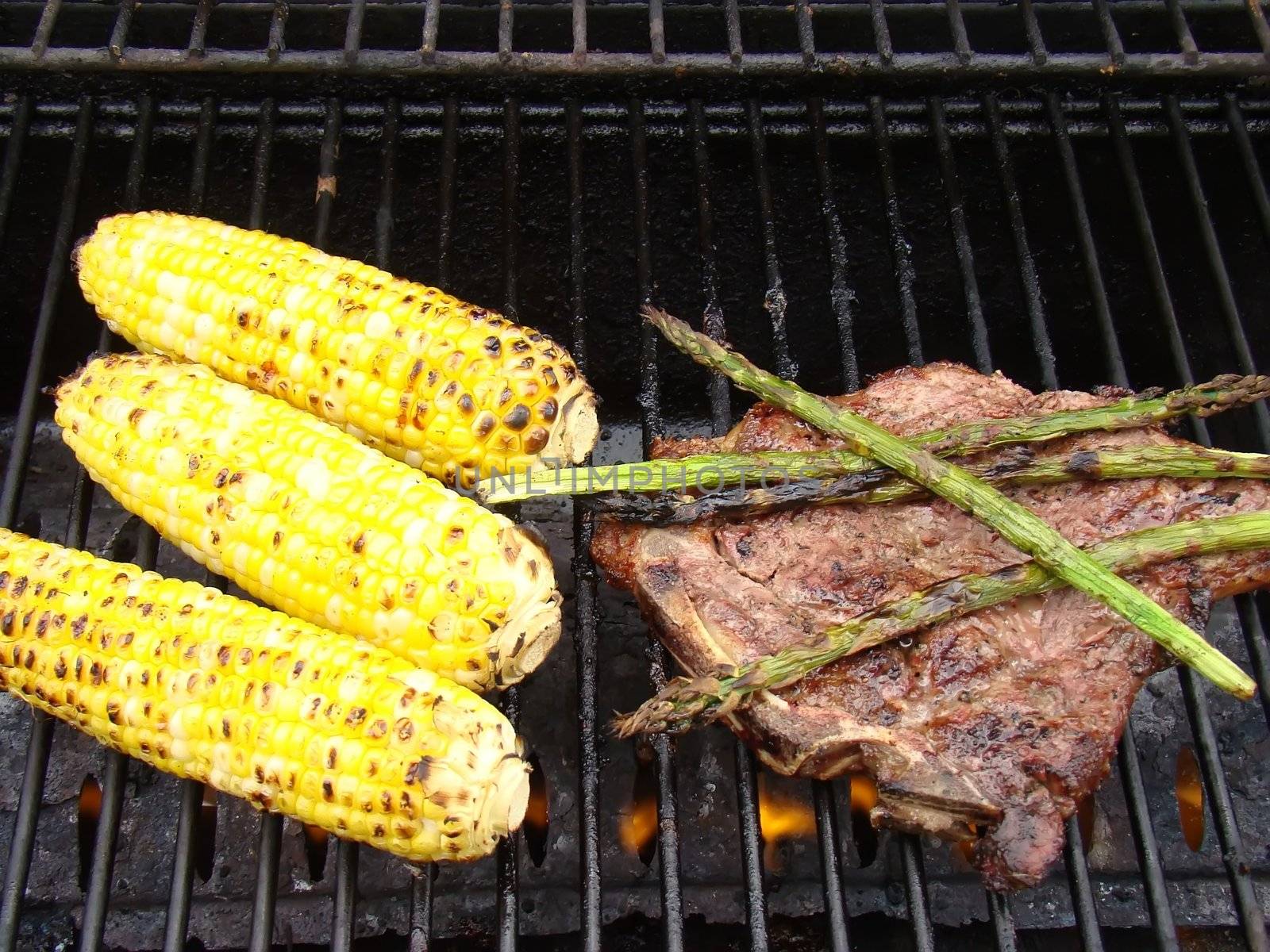 corn ,steak and asperagus on the bbq
