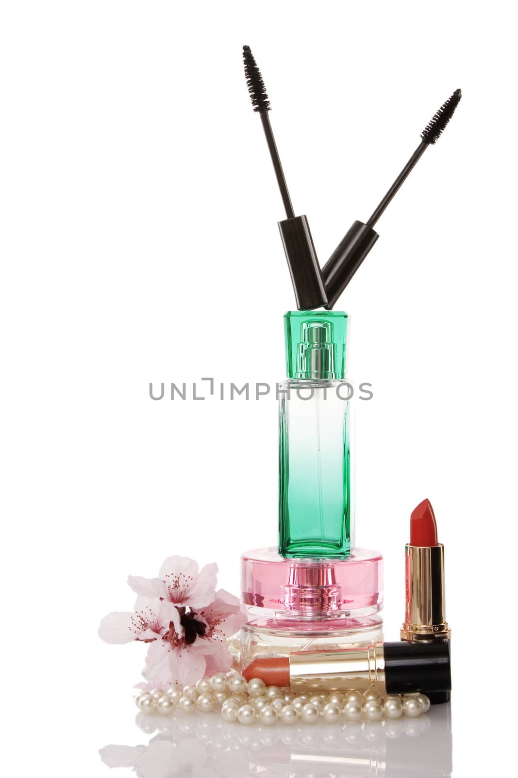 Pearls beads, cosmetics parfume and flower on white background