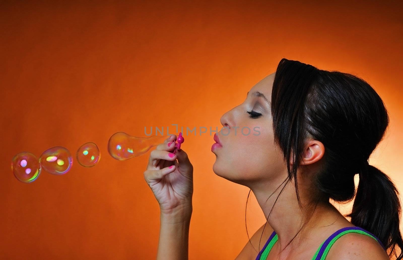 a beautiful young woman having fun with bubbles