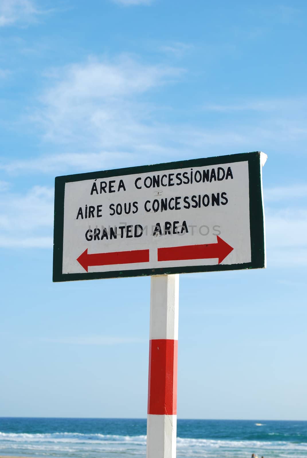 wooden sign at the beach in different languages