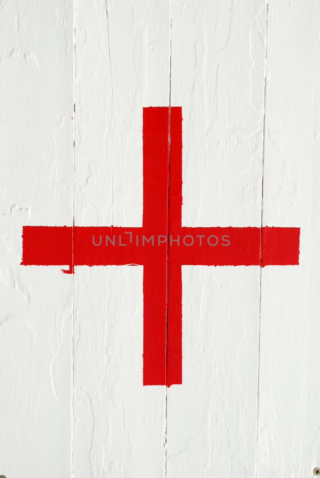 red emergency cross on a white wooden background