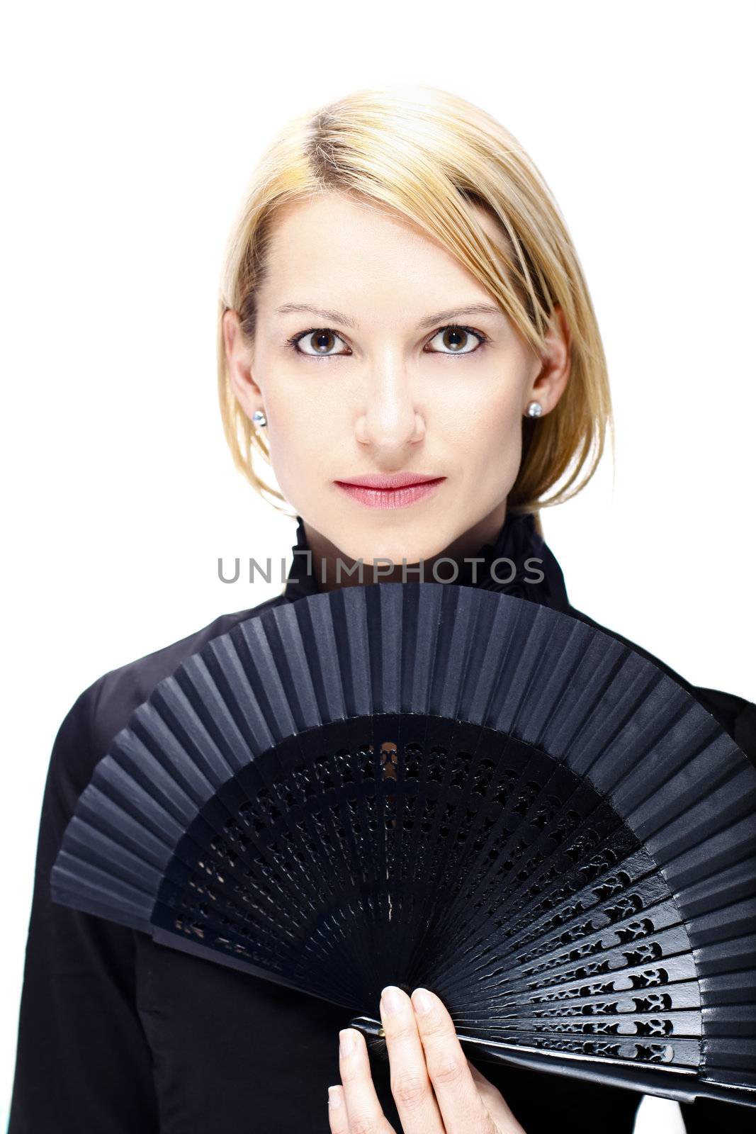 Portrait of a successful,  elegant, atractive, woman wearing black blouse holding folding fan.