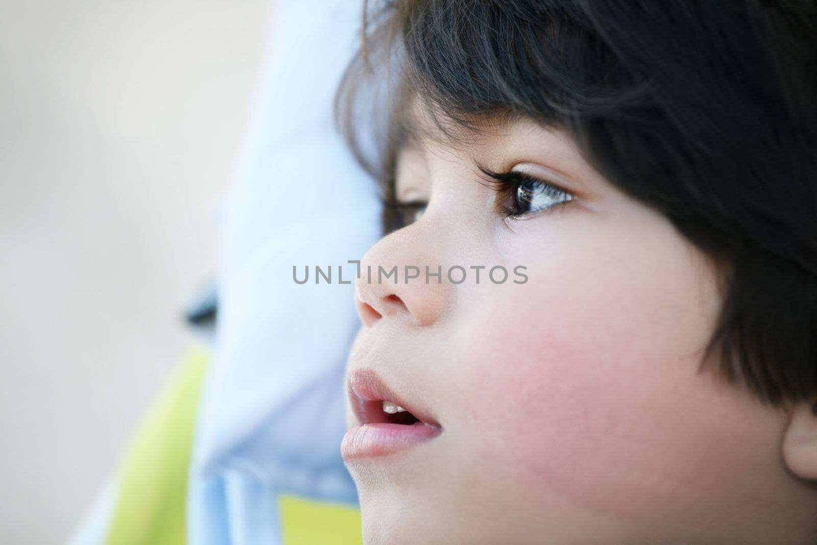 Handsome toddler boy profile, looking off to side