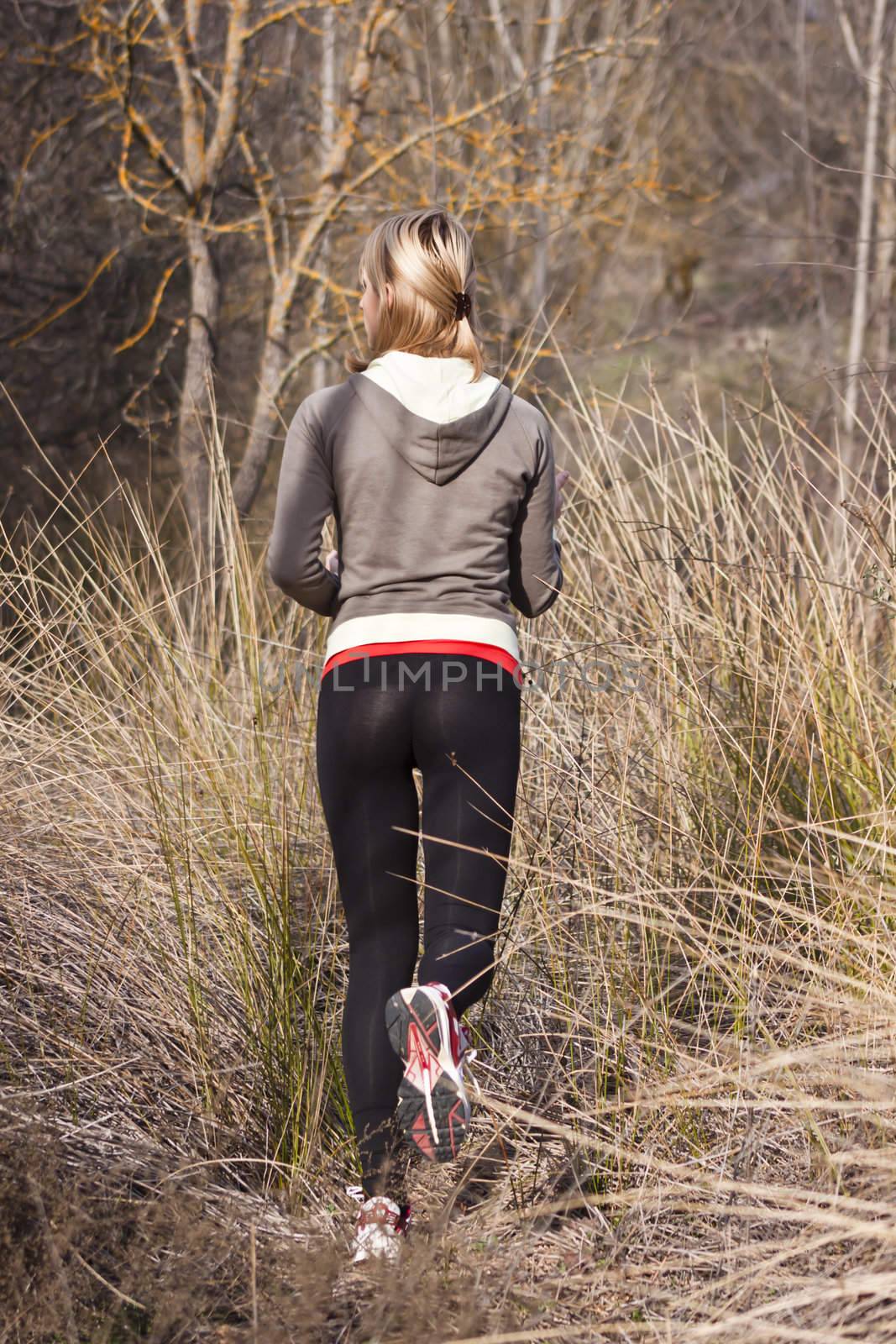 Young beautiful girl running in the autumn environment.