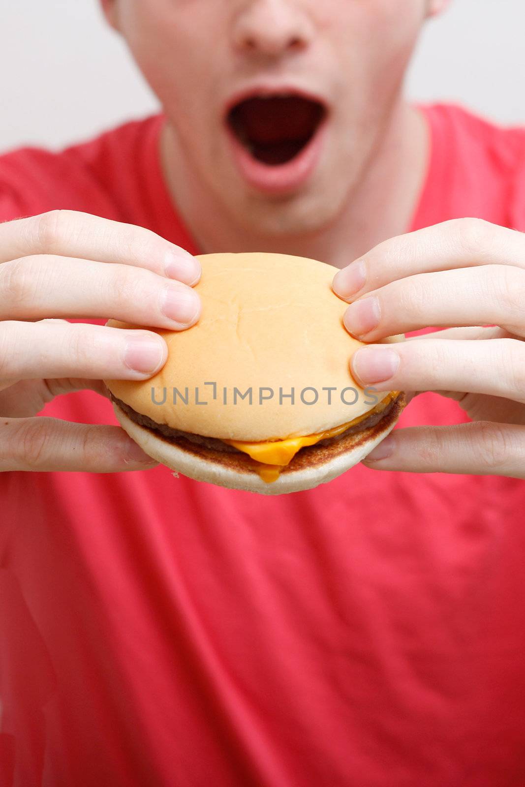 Man eating burger by leeser
