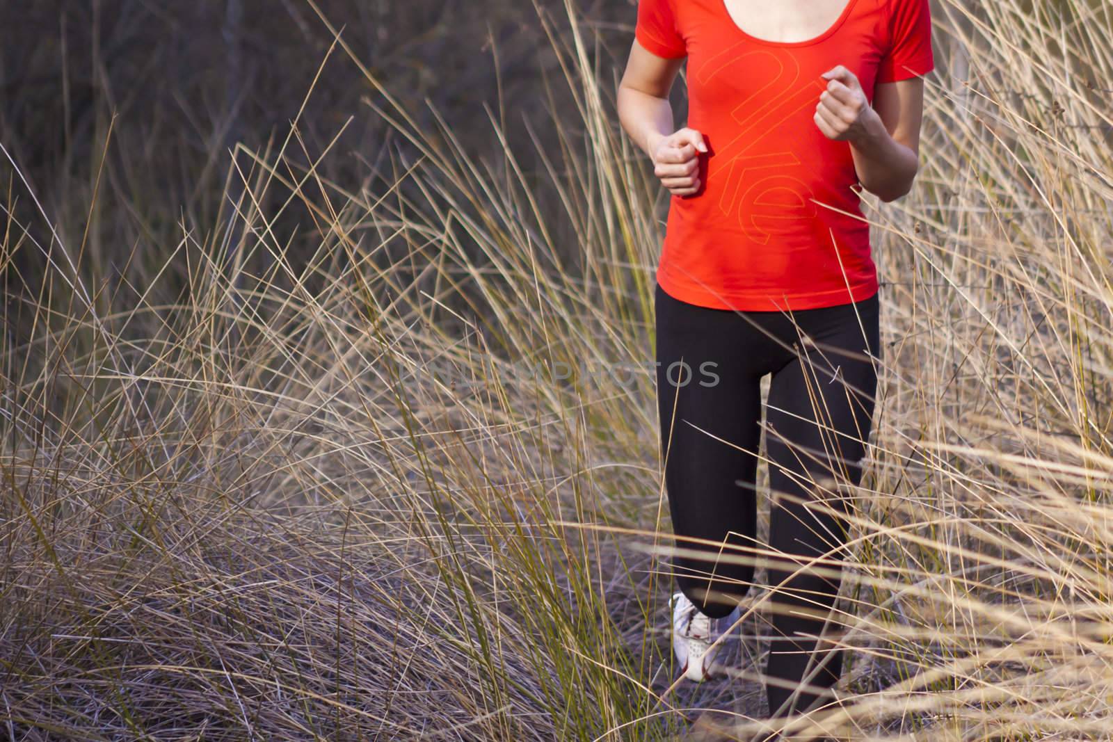 Young beautiful girl running in the autumn environment.