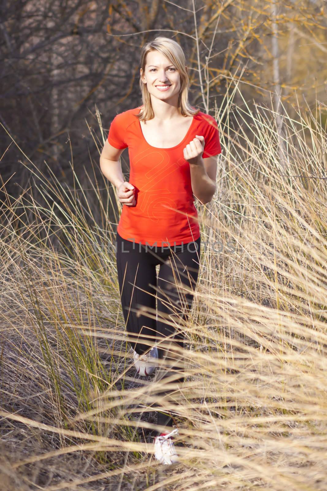 Young beautiful girl running in the autumn environment.