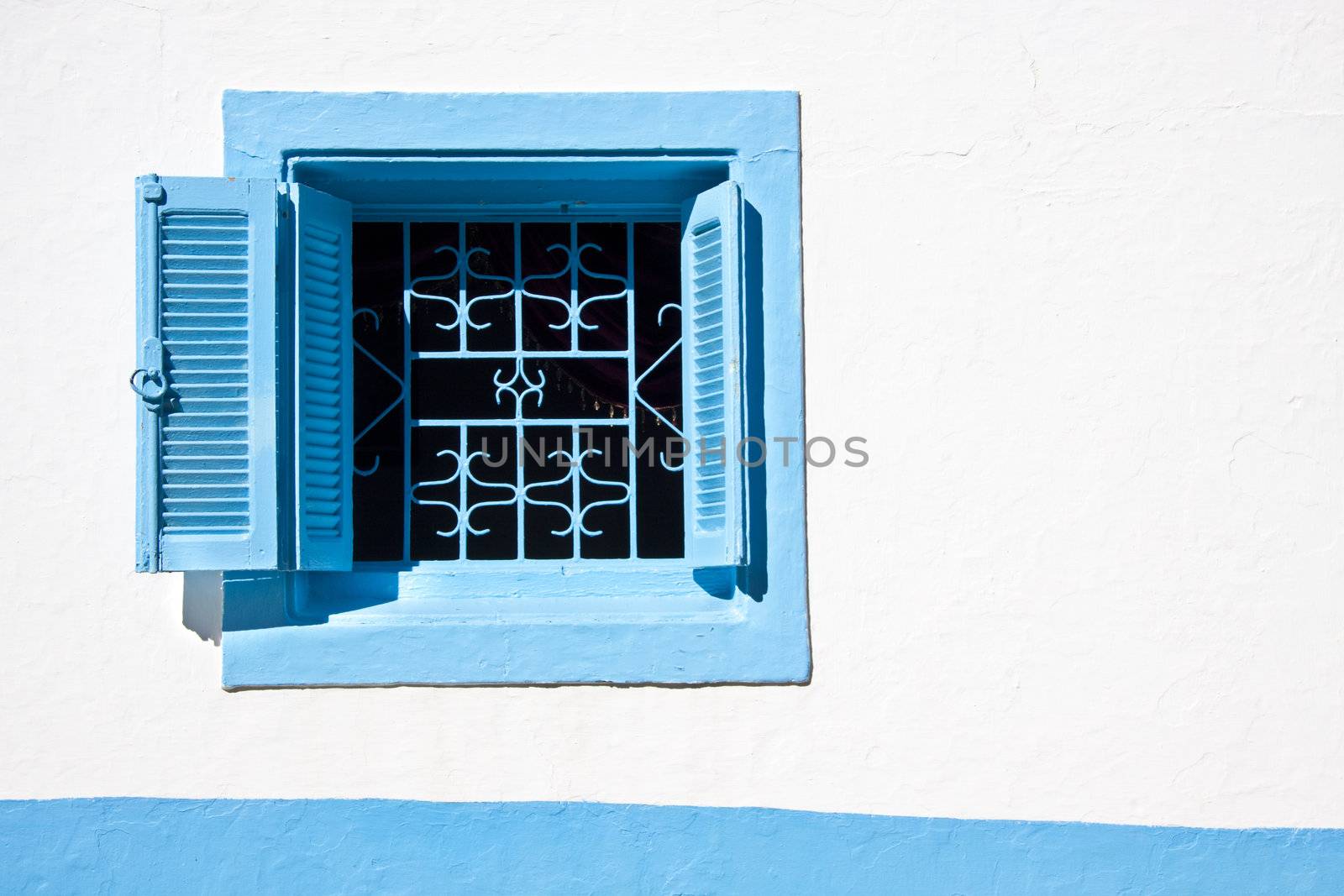 Typical mediterranean small, square, vintage blue window