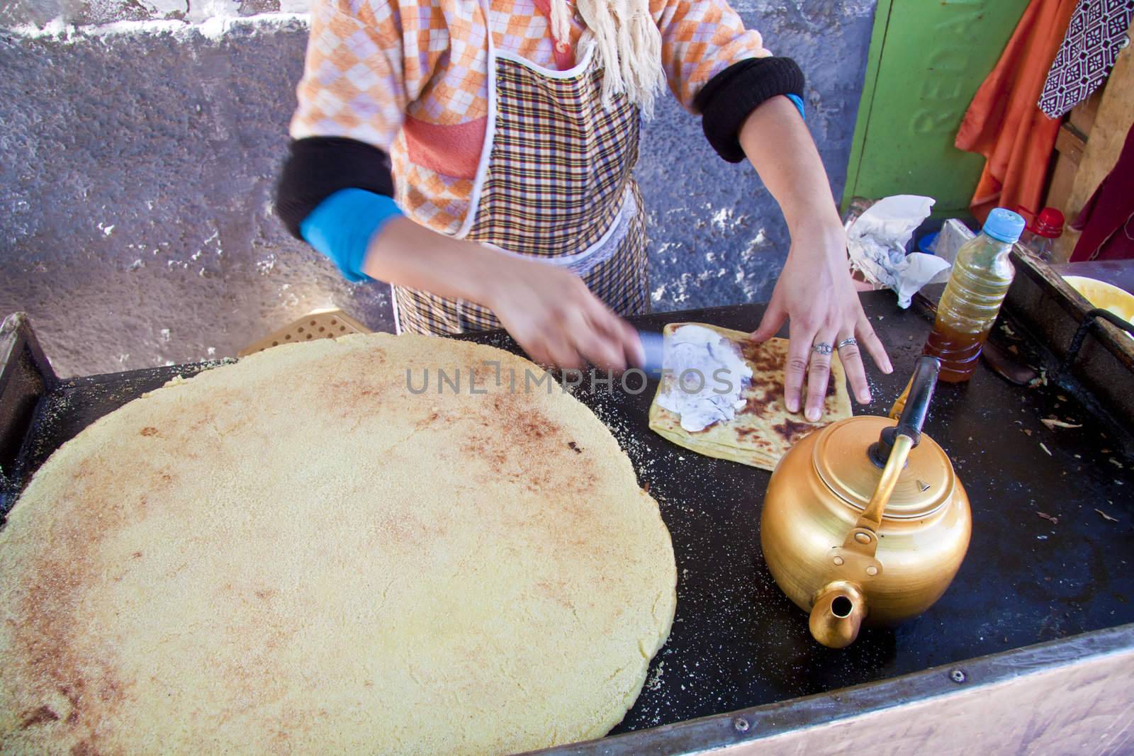 Woman baking delicious moroccan pancakes popular for traditional braeakfasts.