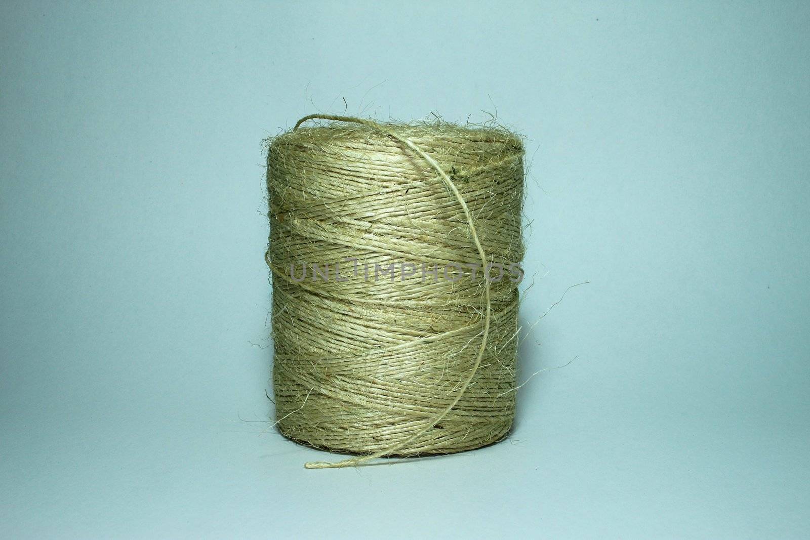 Detail of spool of string on a white background