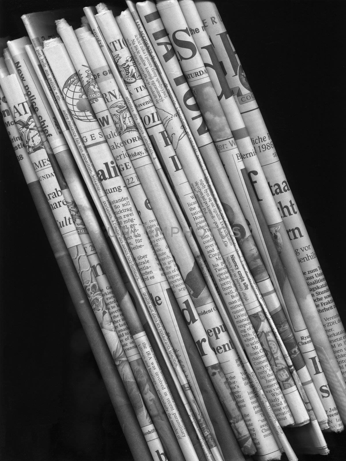 Stack of international newspapers - in black and white