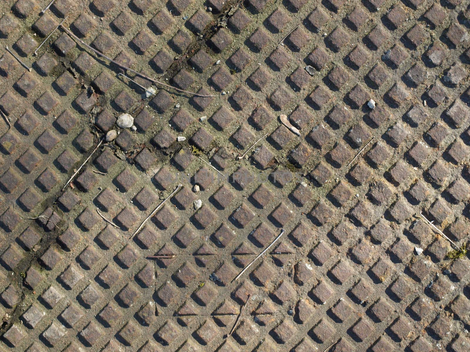 Detail of a rusted steel manhole background