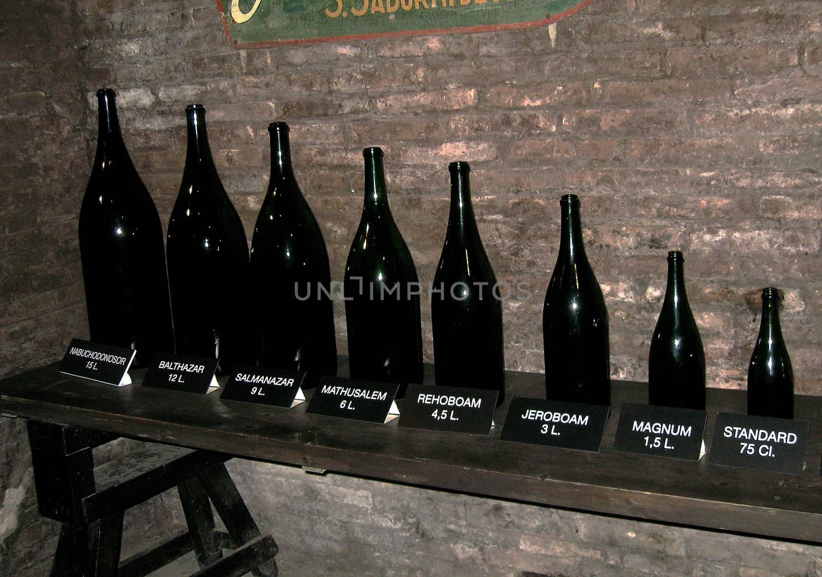 Line of wine bottles in different sizes