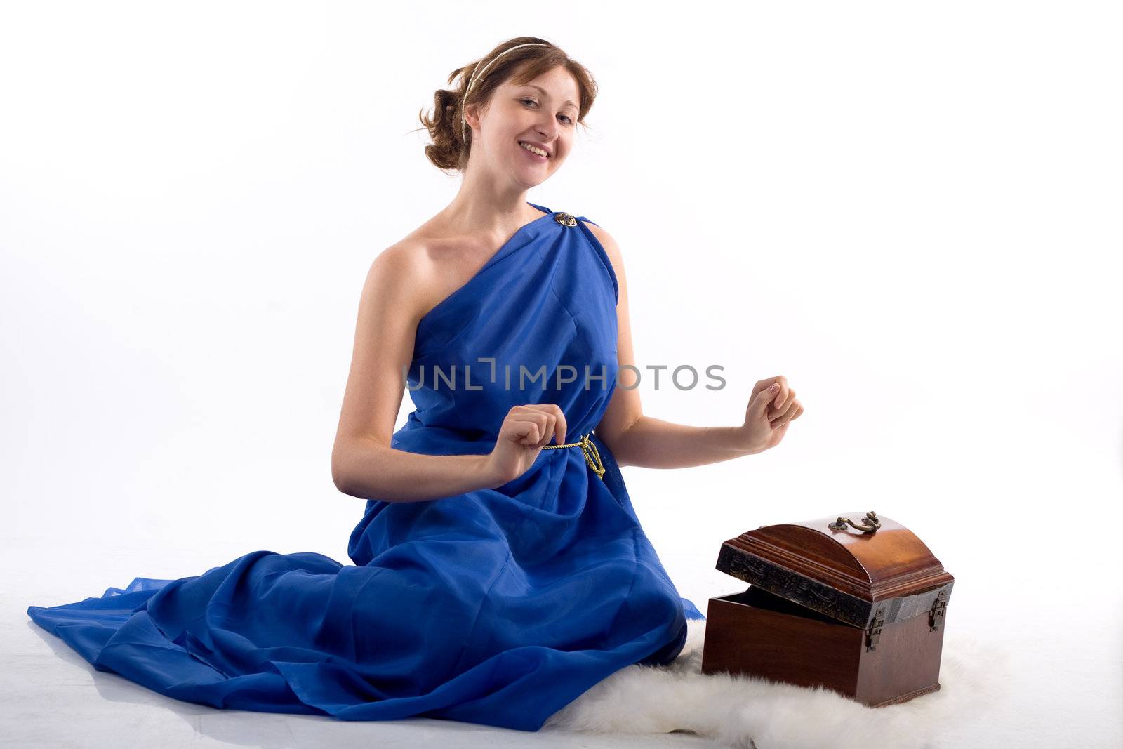 Lady in blue antique dress opening box on white background
