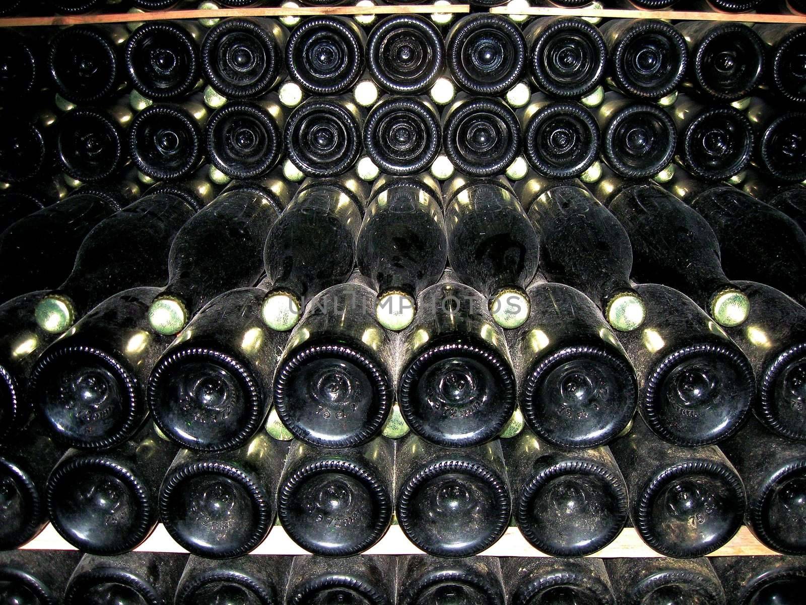 Wine bottles stacked for fermentation in cellar