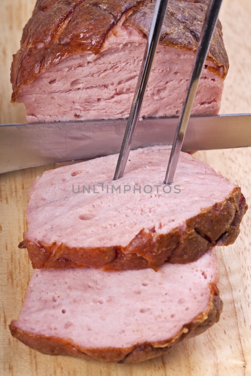 baked bavarian meat loaf on a wooden desk by bernjuer