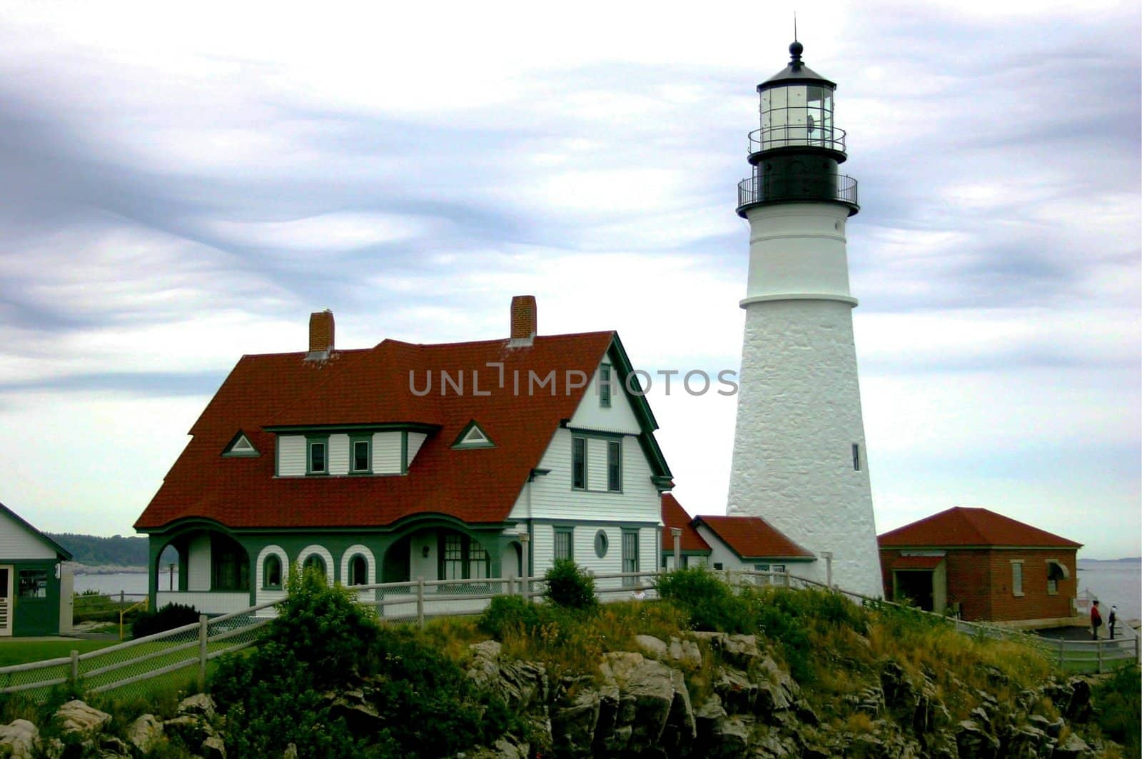 Portland Maine coastline lighthouse with a stormy cloud background