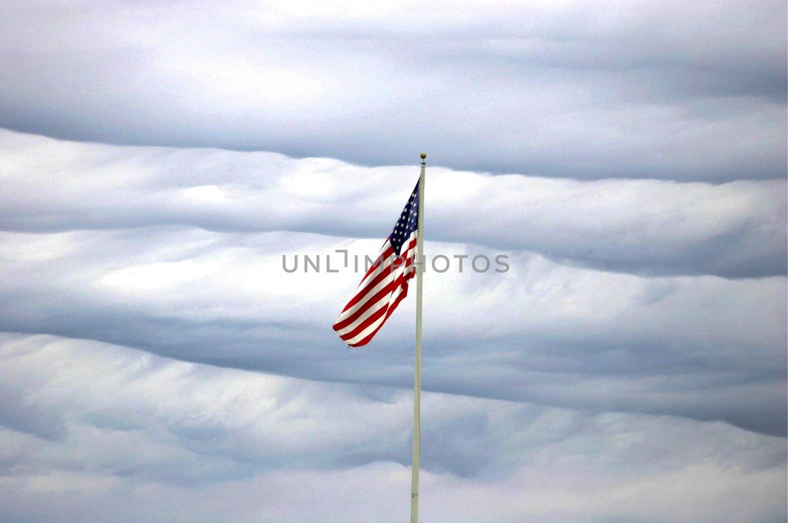US flag on wavy cloud background
