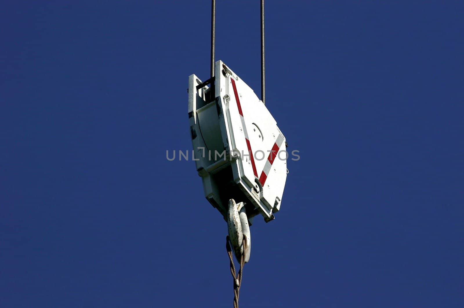 Silhouette of crane hook on blue background