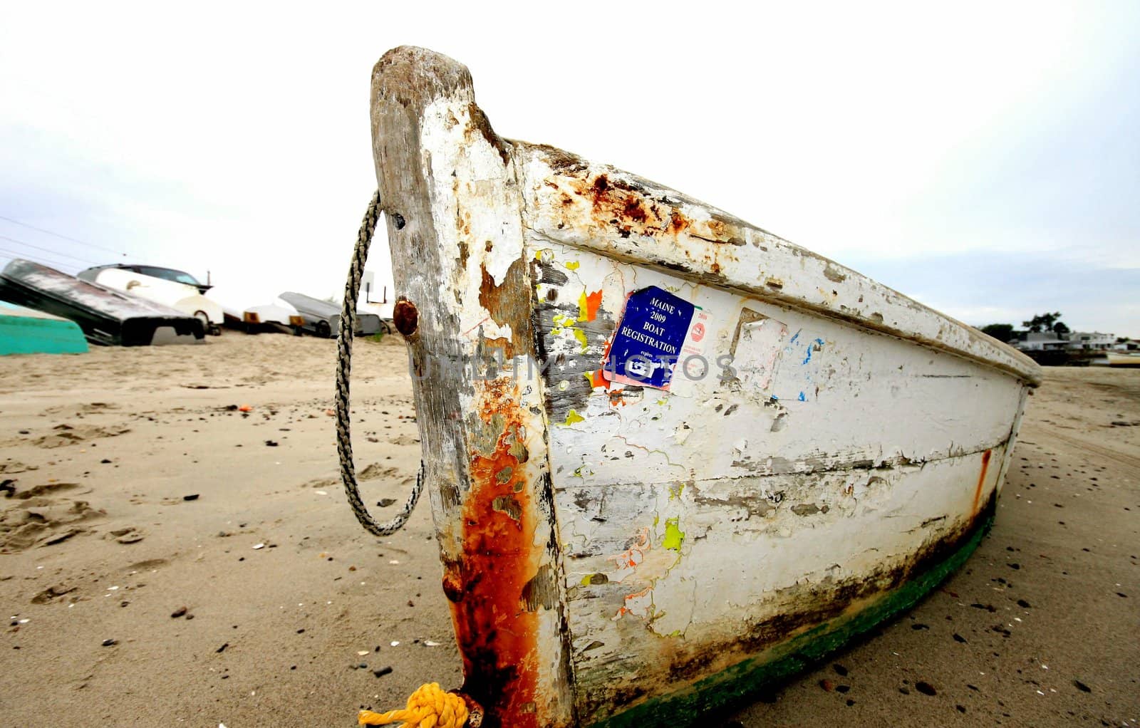 Rusty fishing boat on Maine coastline at low tide