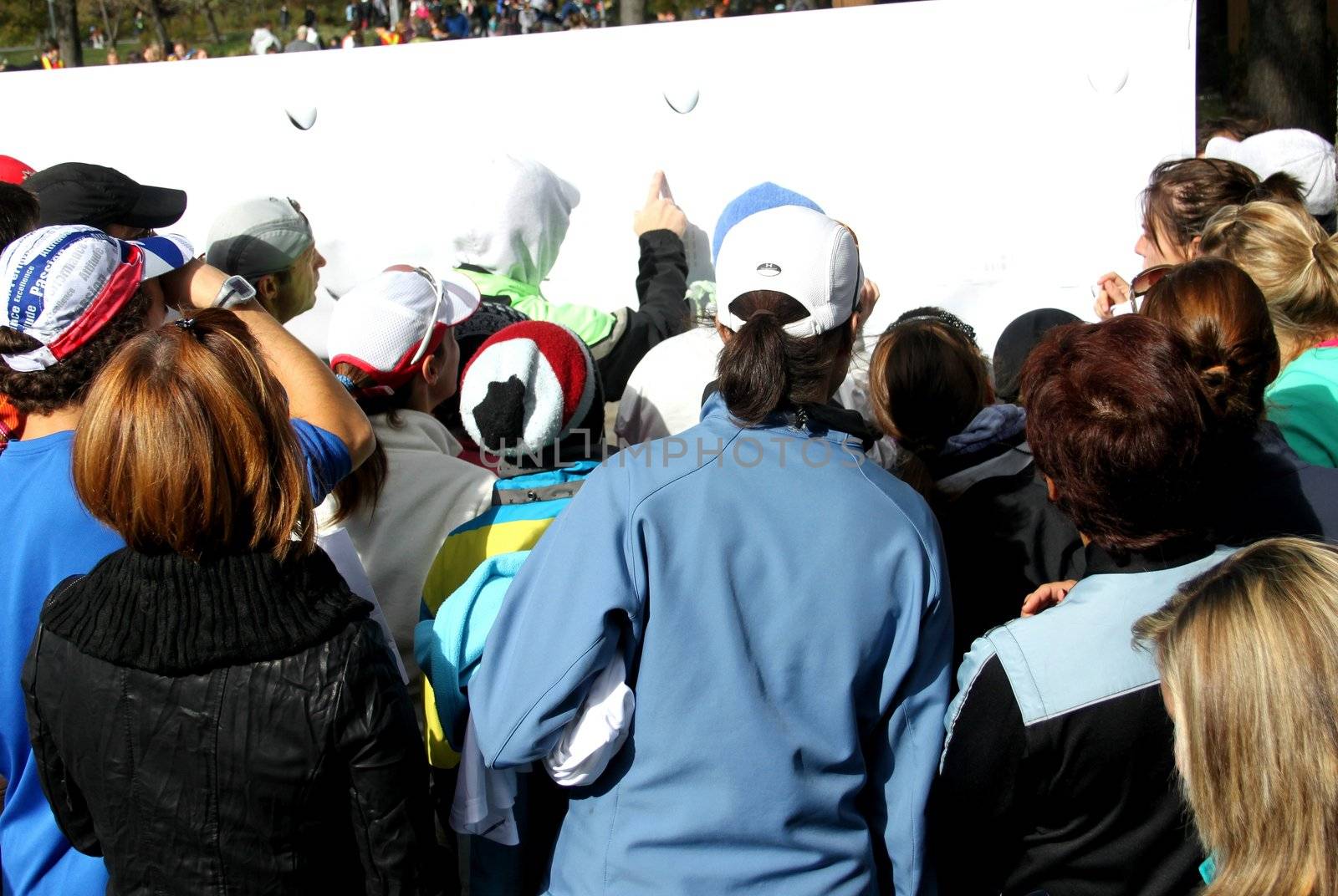 People in front of board in an outside event