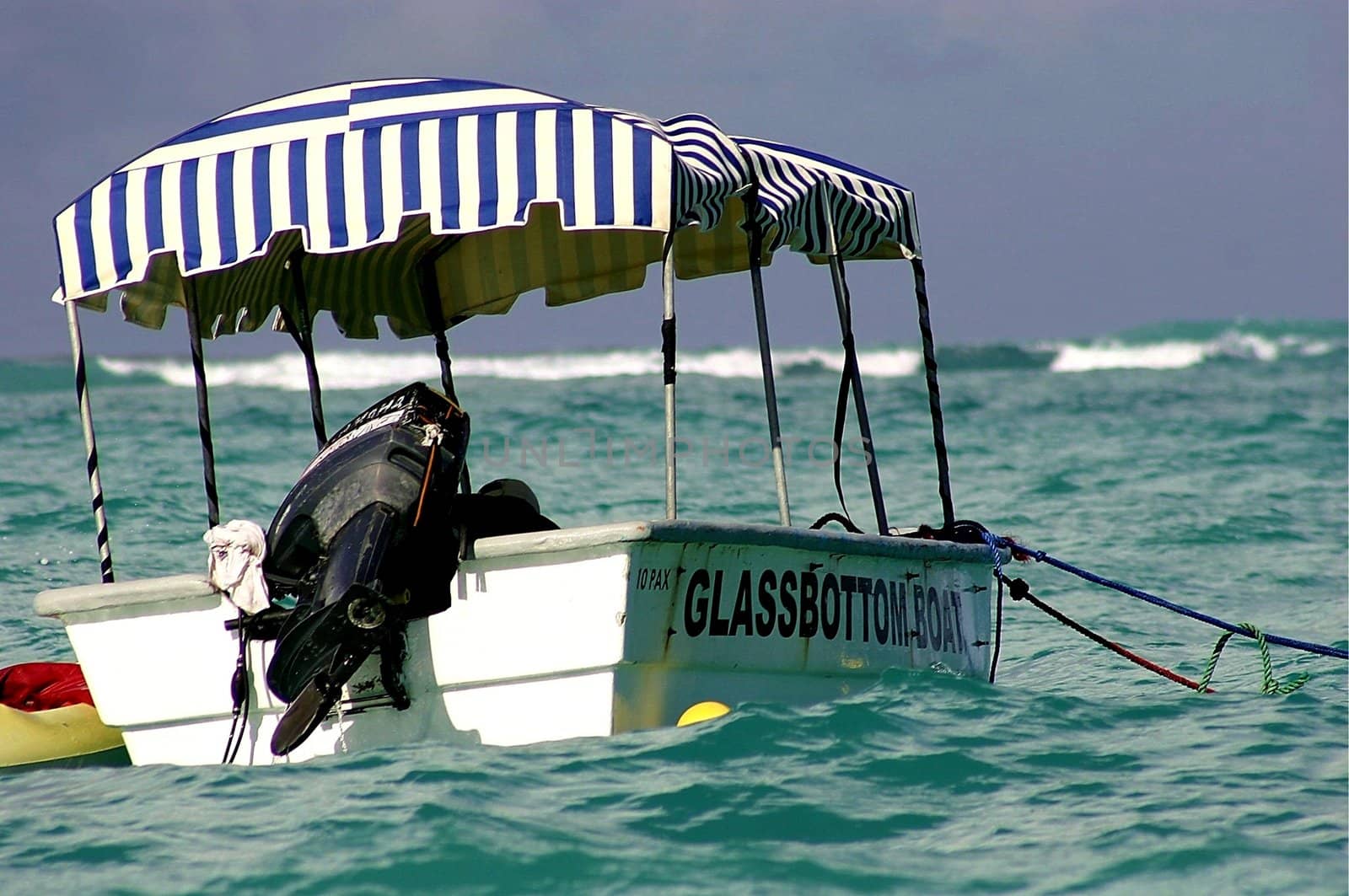 Small glass bottom boat anchored near Carabean Island