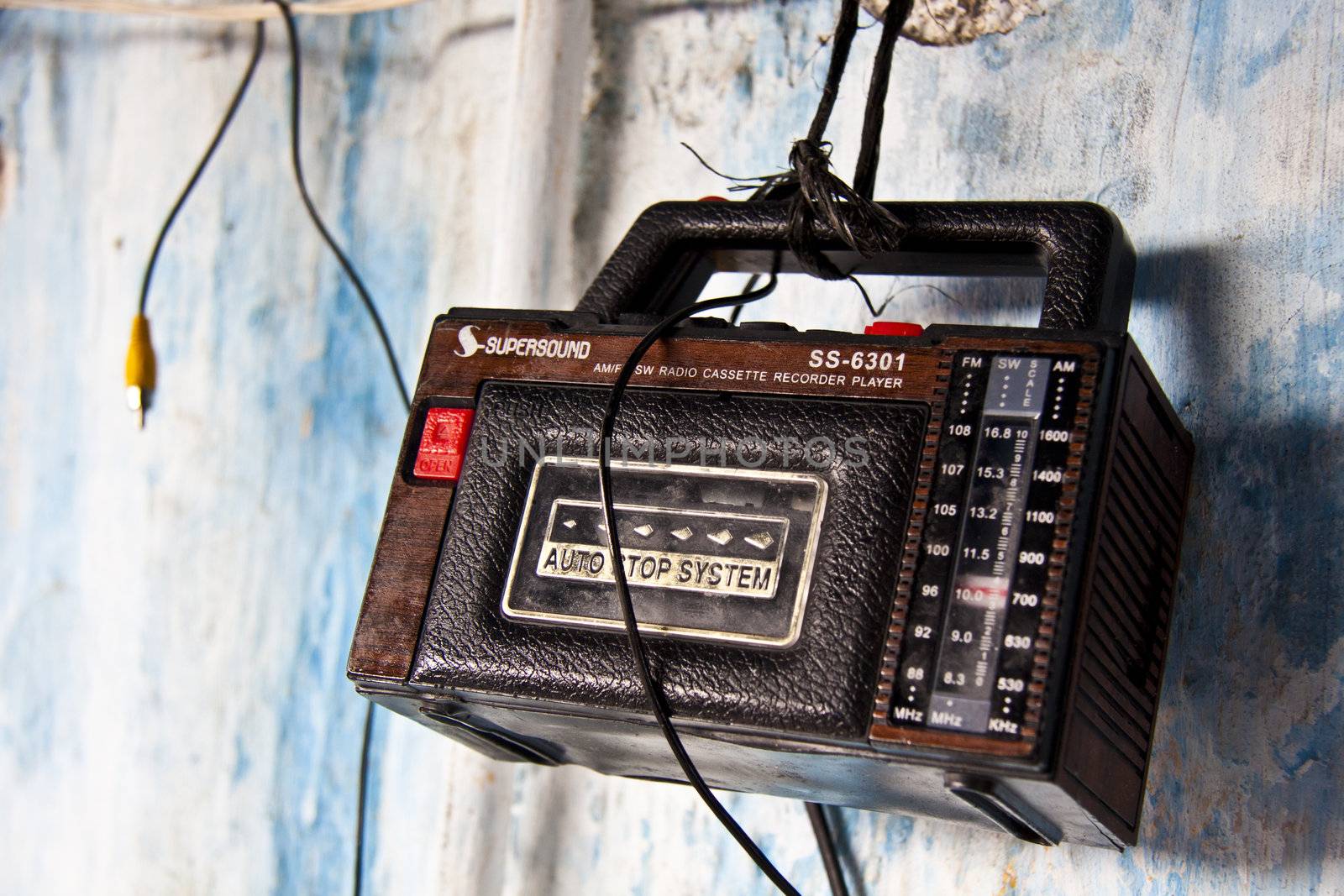 Retro radio with a cassette player hanging on the wall