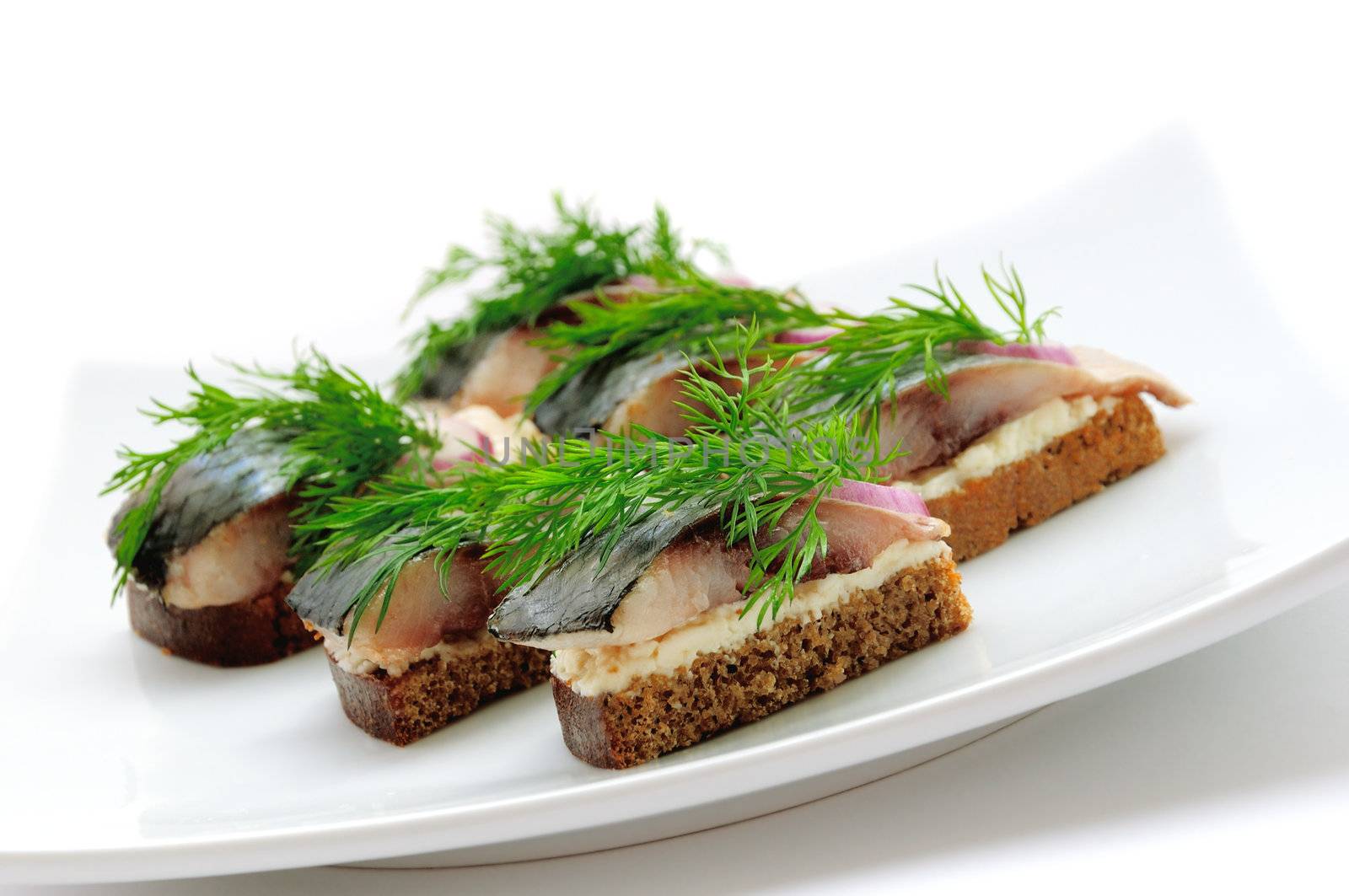 Sandwiches of rye bread with herring, onions and herbs. by Apolonia